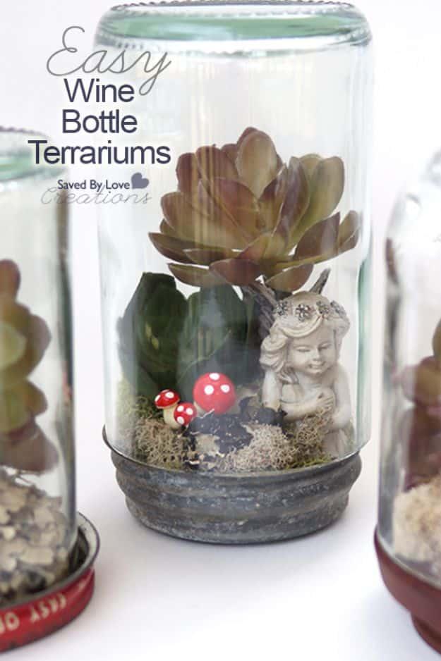 Wine bottle terrarium, a cut glass bottle cloche over a succulent a small cherub figure and two red toadstools