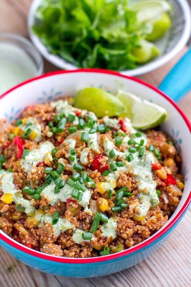 Teal blue bowl with a red rim holding Mexican instant pot quinoa with corn, peppers and lime wedges on top