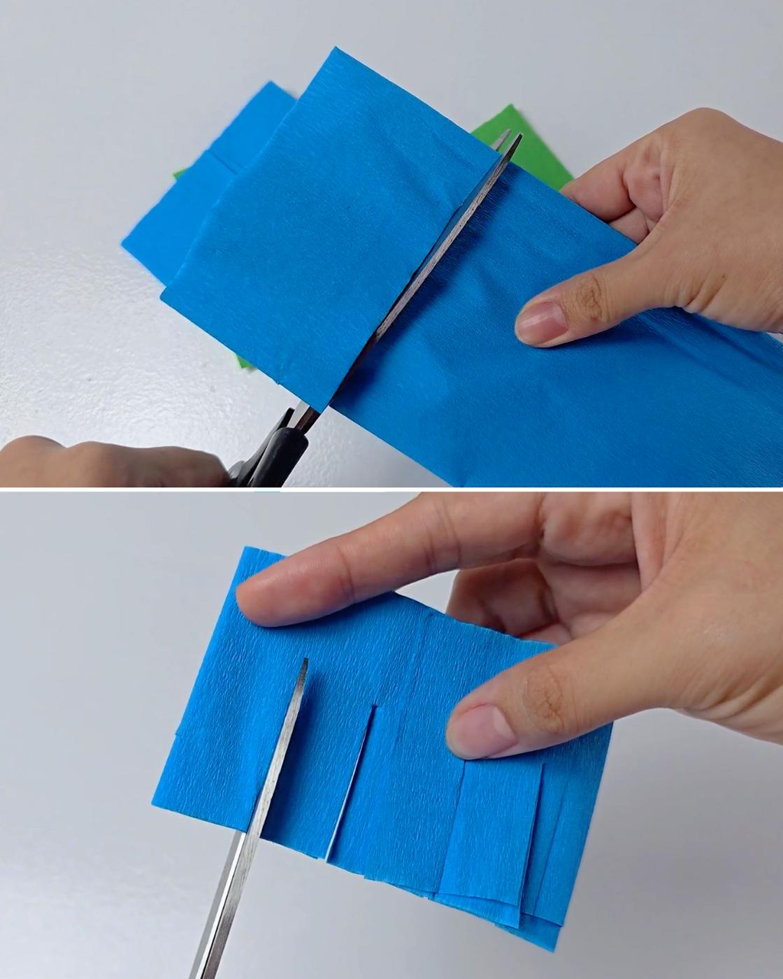 How to Make a Pinata Shirt - scissors cutting a folded crepe paper strip, then cutting fringe notches along the edge