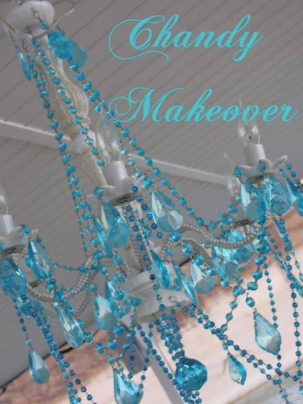 Outdoor chandelier makeover with white frame and swapped aqua crystal bead strands hanging under a covered ceiling