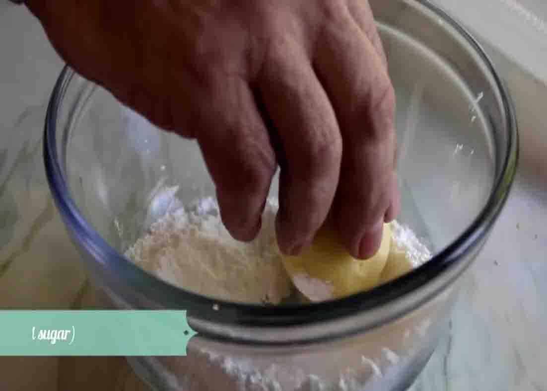 Coating the lemon cookies with powdered sugar