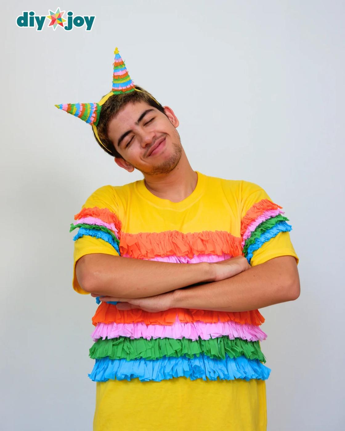 Easy Halloween Costume Ideas - close up of a young man wearing the fringe shirt and headband, laughing against a wall.