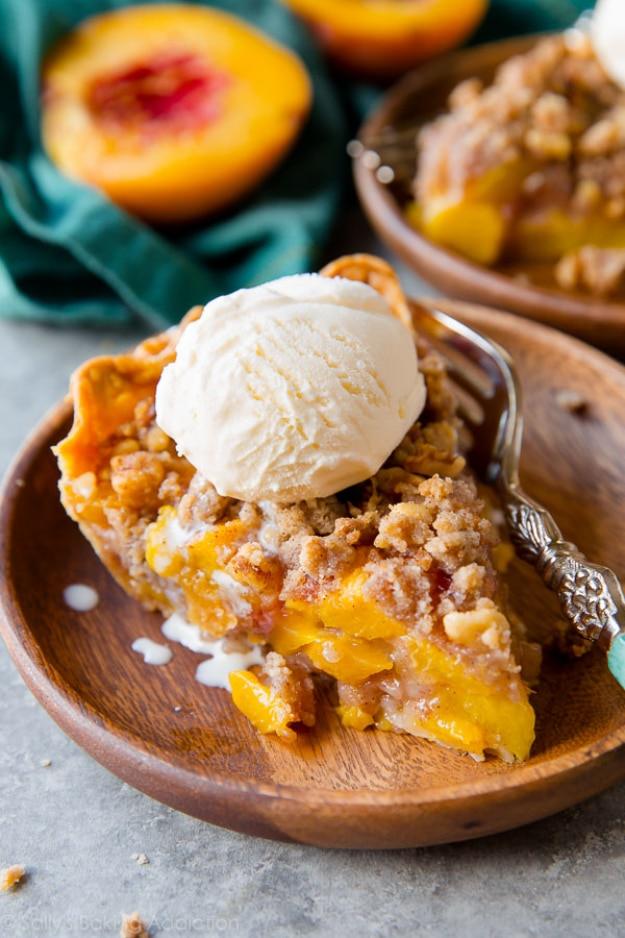 Brown sugar peach crumble pie with juicy peach slices under a golden brown crumb topping in a flaky crust