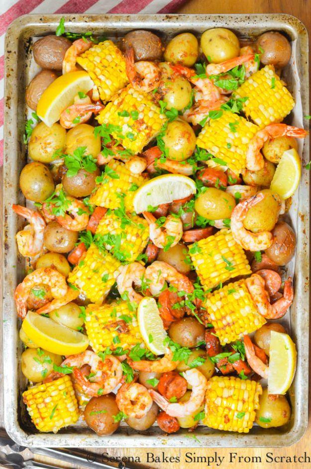 Cajun shrimp sausage sheet pan dinner with baby potatoes, corn rounds, andouille and shrimp on a baking tray