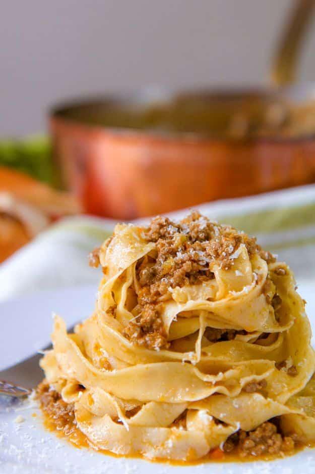 Ragu alla Bolognese, a slow simmered Italian meat sauce spooned over fresh pasta and dusted with cheese