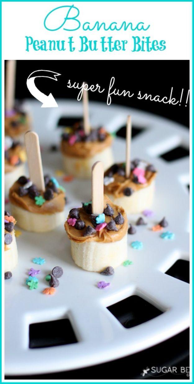 Banana peanut butter bites on mini popsicle sticks topped with chocolate chips and sprinkles, a fast after school snack