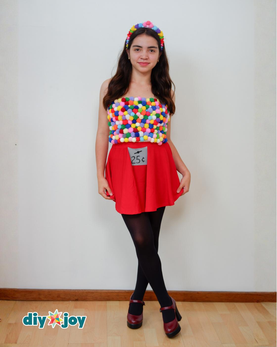 DIY Costumes - woman in the gumball machine outfit, a pom pom crop top over a red circle skirt with a 25 cent label