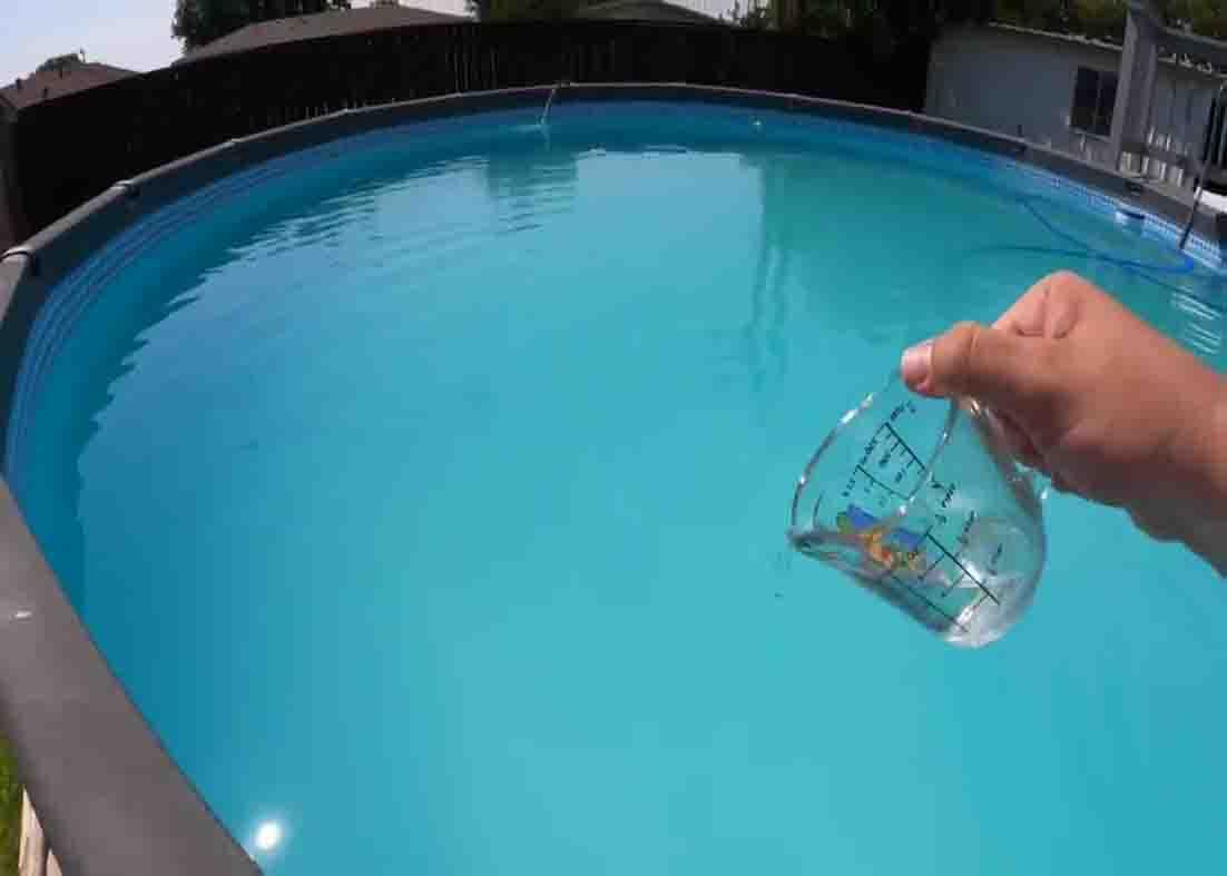 Pouring the flocculant solution to the pool