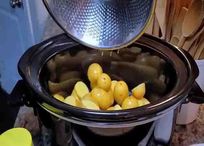 Adding the potatoes to the crockpot