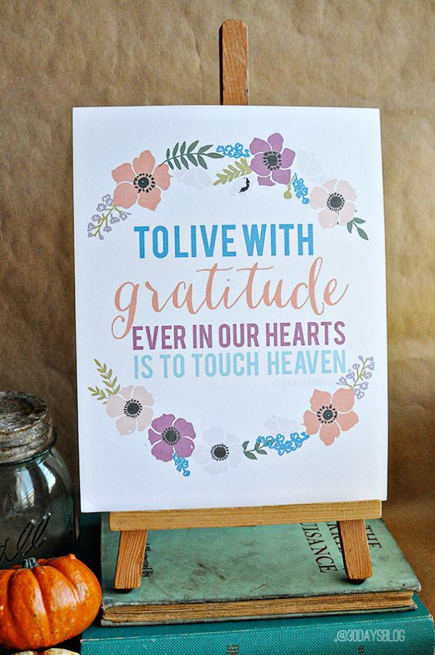 Printable gratitude quotes, a hand lettered gratitude quote ringed with painted anemones, propped on a wooden easel on old