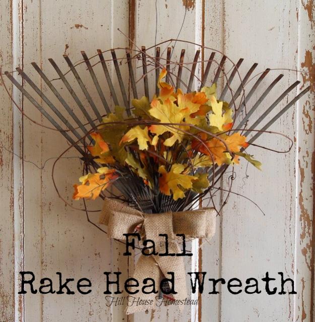 Old rake head with the tines fanned out and filled with foliage, an unusual fall wreath for a front door