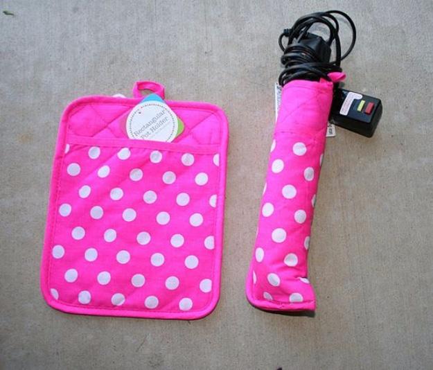 Pink and white polka dot quilted potholder beside a matching sewn sleeve holding a flat iron with its cord wrapped