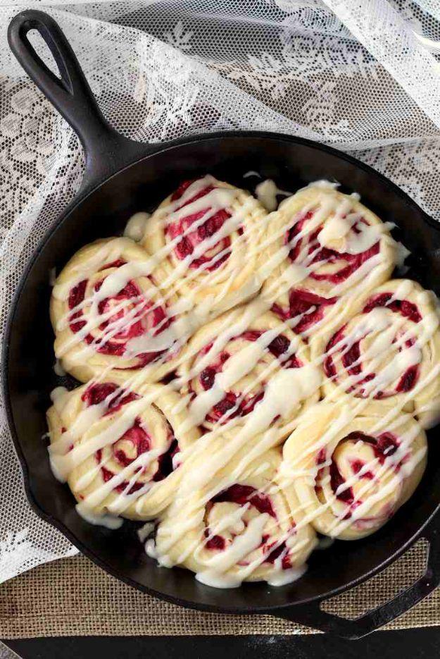 Raspberry cream cheese sweet rolls in a pan, swirled with cream cheese filling and baked raspberries