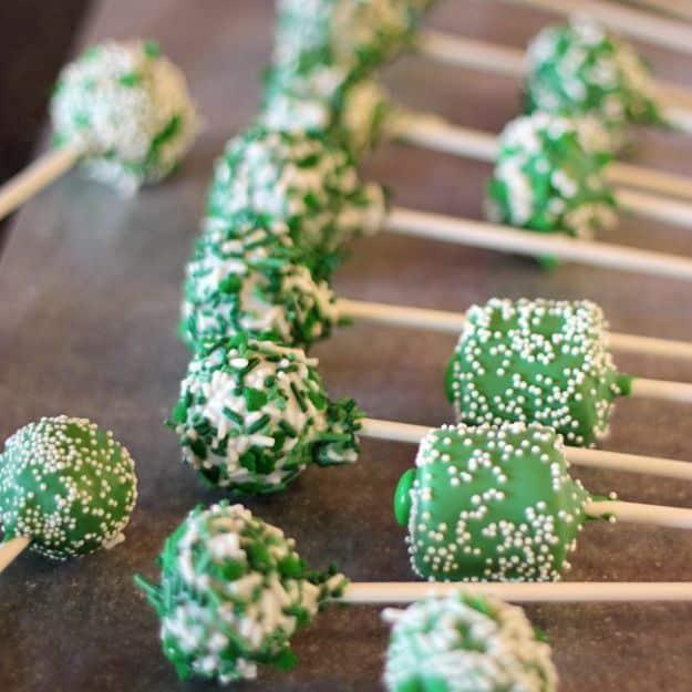 Green velvet cake pops with vivid green cake inside a white candy shell for St Patricks Day, a festive holiday dessert idea