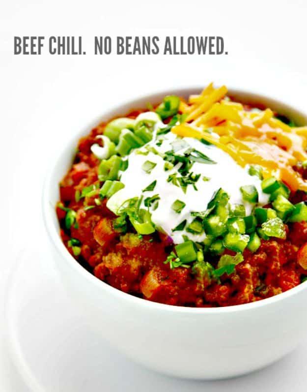 Graphic with the words Beef Chili No Beans Allowed above a white bowl of red chili topped with sour cream