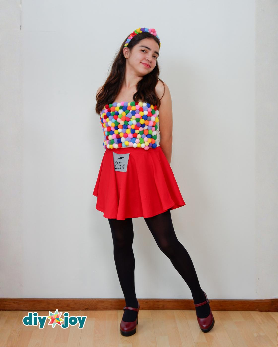 How to Make a Gumball Machine Costume - side view of the finished outfit showing the pom pom top, red skirt and 25 cent label
