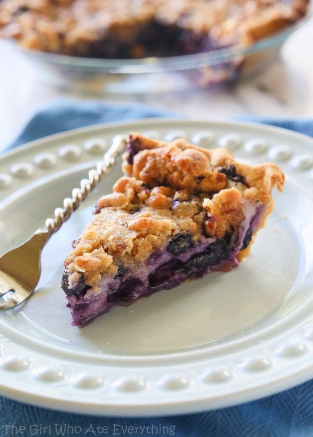 Blueberry custard pie with dark blueberries set in creamy custard under a crunchy streusel crumb topping