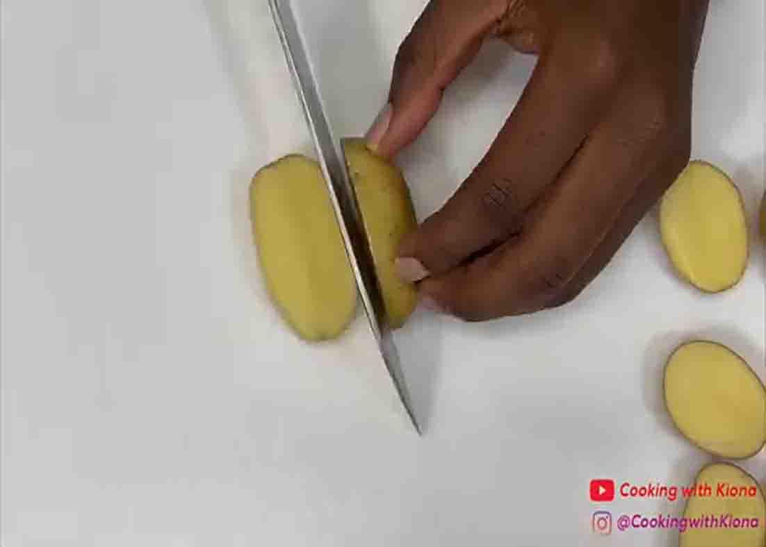 Cutting the potatoes in half for the parmesan crusted potatoes