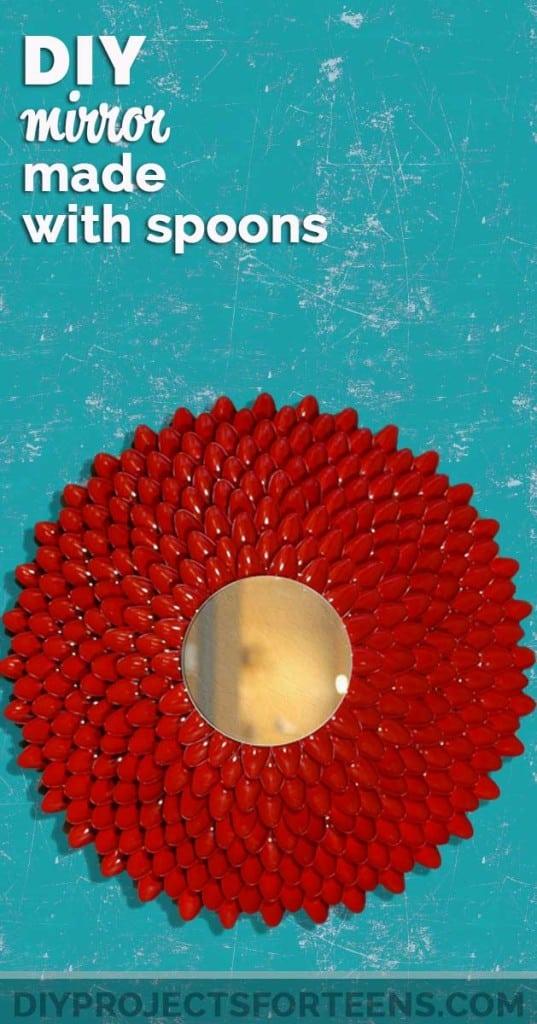 DIY mirror made with plastic spoons, a red petal mirror of painted spoon bowls on a teal typeset background