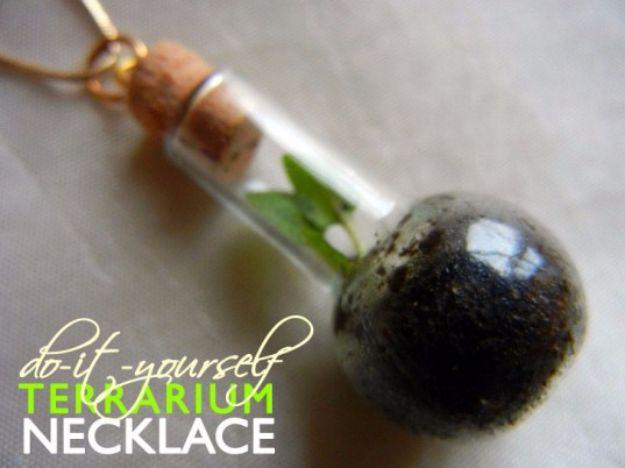 DIY terrarium necklace, a corked glass vial pendant of dark soil and a small green plant hanging on a brown cord
