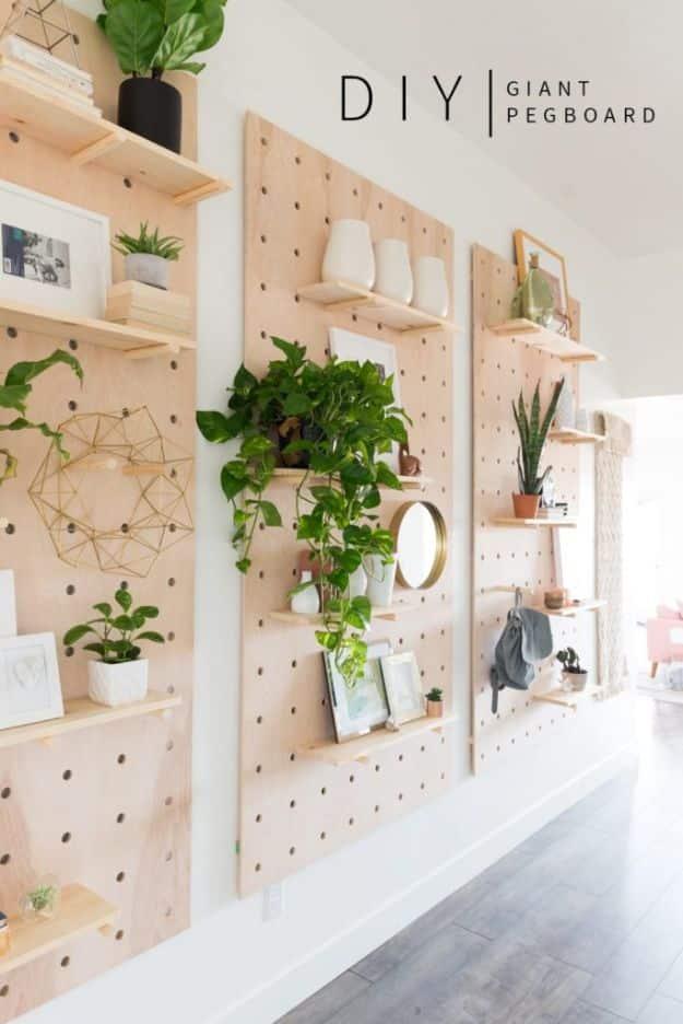 Giant wooden pegboard wall with shelves and plants, a beginner friendly DIY home decor project for a big wall