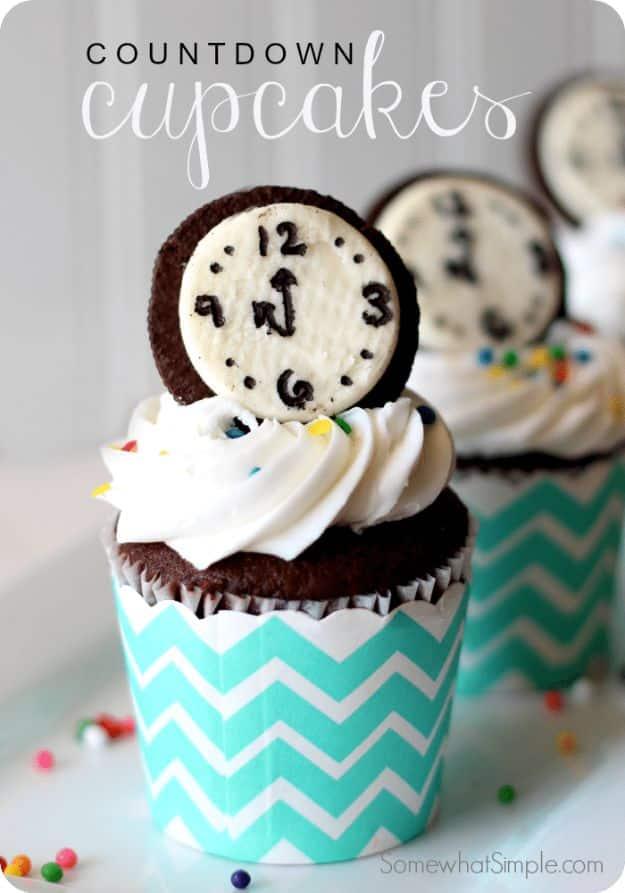 New Year's Eve countdown cupcakes topped with Oreo cookie clock faces, white frosting and colored sprinkles