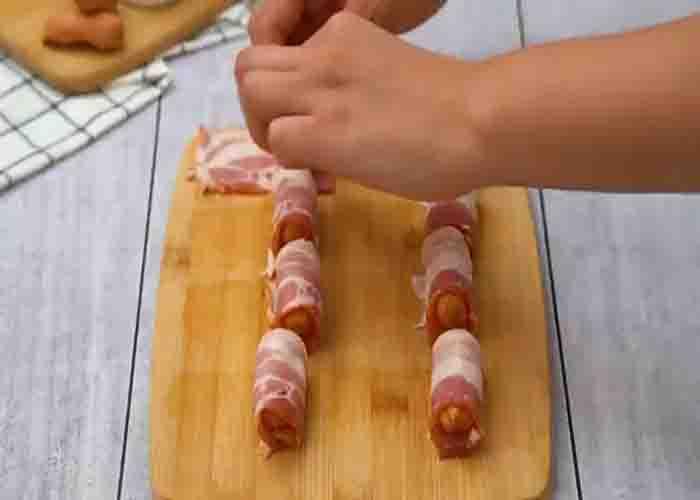 Wrapping each lil smokie with bacon