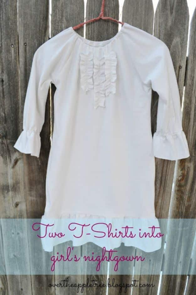White ruffled nightgown made from two t-shirts, hanging on a pink hanger against a weathered wood fence