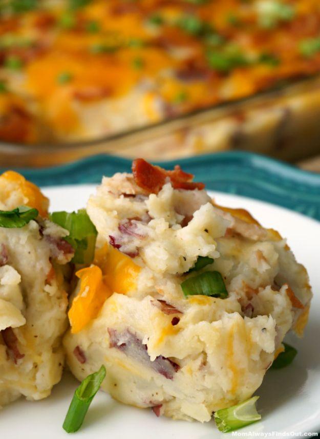 Plate of loaded baked potato casserole with melted cheddar, bacon and green onion beside the baking dish