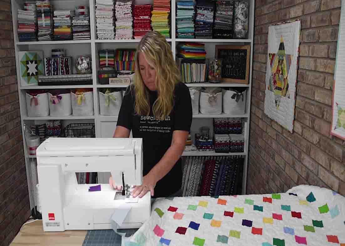 Piecing the printed and background fabric together for the confetti quilt
