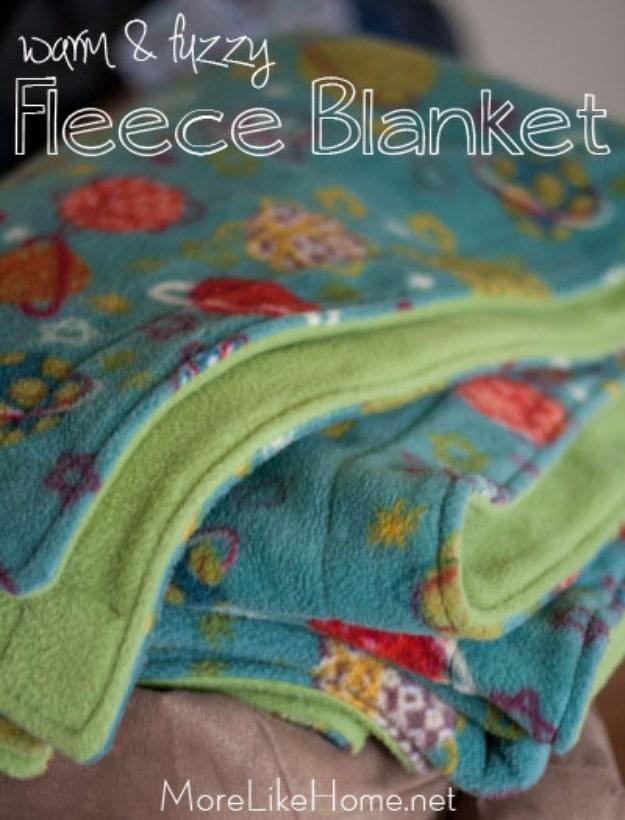Folded fleece blankets in turquoise print and lime green stacked in a pile, under a typeset script title