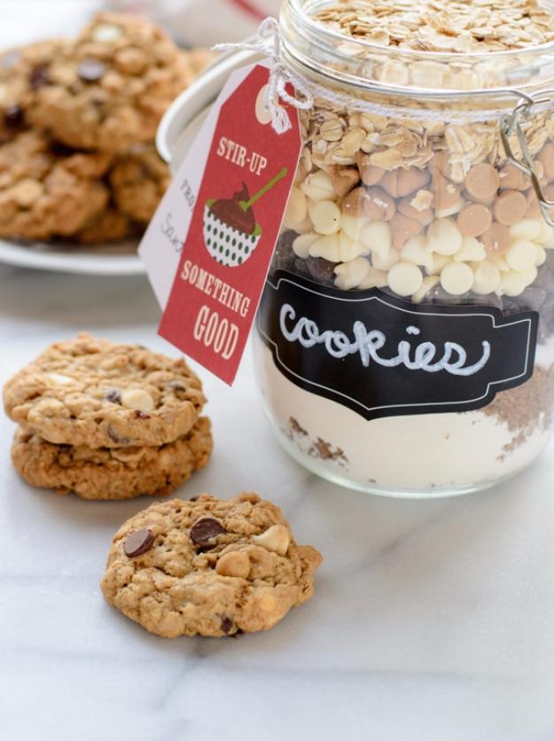 Clamp lid glass jar of triple chip oatmeal cookie mix beside a plate of freshly baked oatmeal cookies