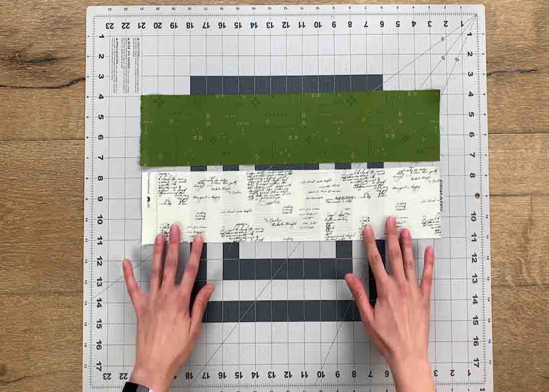 Piecing two different strips together for the quilt