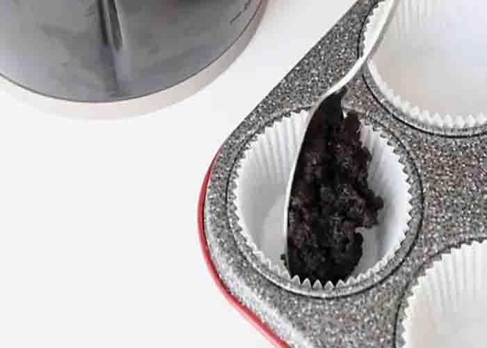 Dividing the Oreo crust into the cupcake tray