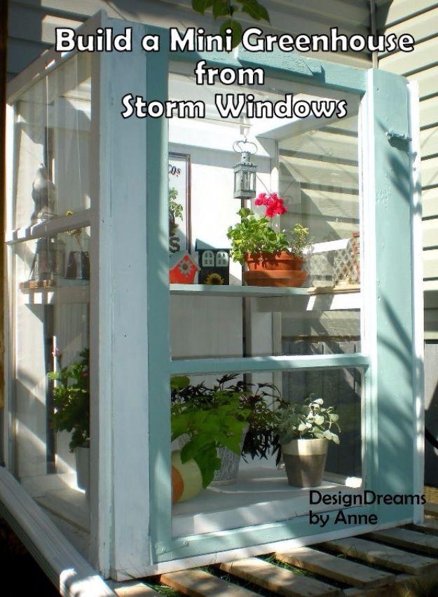 Build A Mini Greenhouse From Storm Windows, quick to put together in one afternoon and warmth that a bare corner was missing