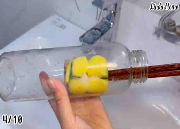 Cleaning a bottle with a kitchen sponge