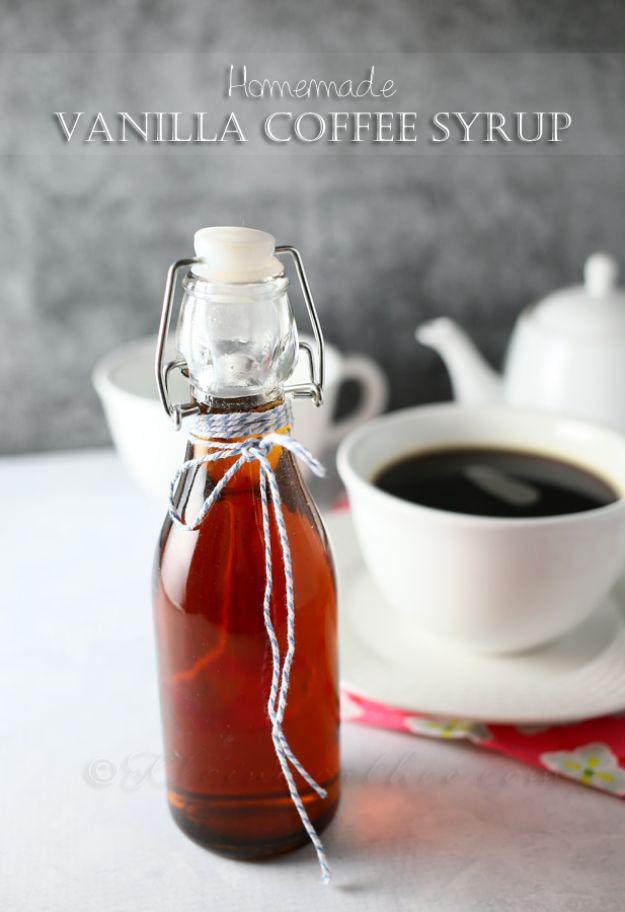 Homemade vanilla coffee syrup in a swing top bottle beside a white cup of black coffee and a small teapot