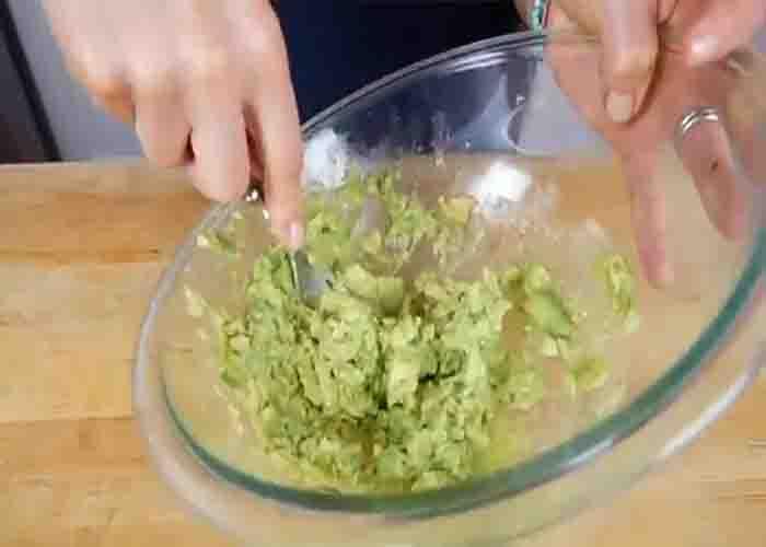 Mashing the avocado for the avocado chicken salad