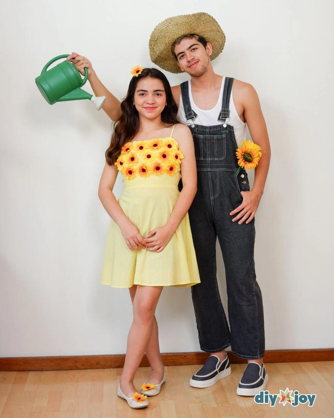 Two adults in sunflower and gardener costumes with flowered yellow dress, denim overalls, straw hat and watering can