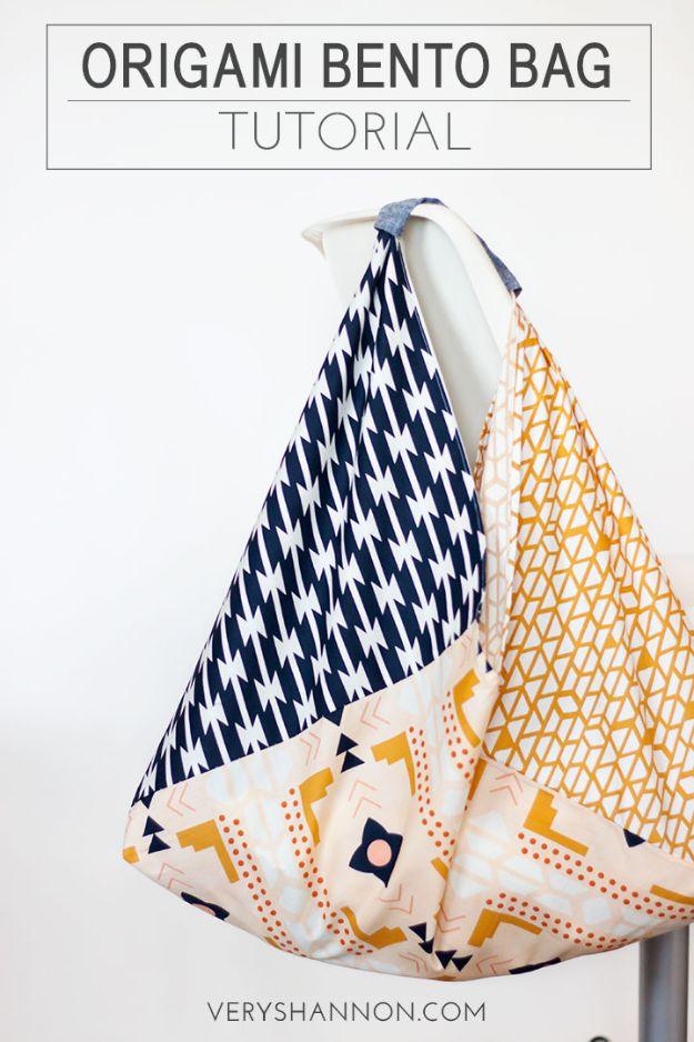 Origami bento bag in navy, mustard and blush fat quarters, hanging by its knotted handles under a typeset title