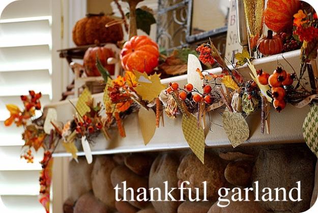 Thankful garland made from a grapevine base with clothespins holding paper leaves guests write blessings on