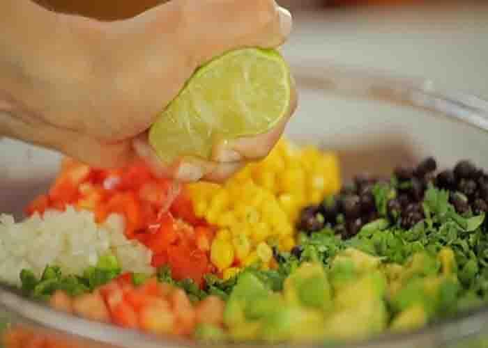 Squeezing the lime to the cowboy caviar salsa