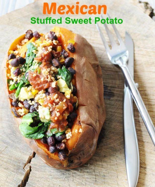 Mexican stuffed sweet potato split open and filled with black beans, corn, spinach and cashew crumbles