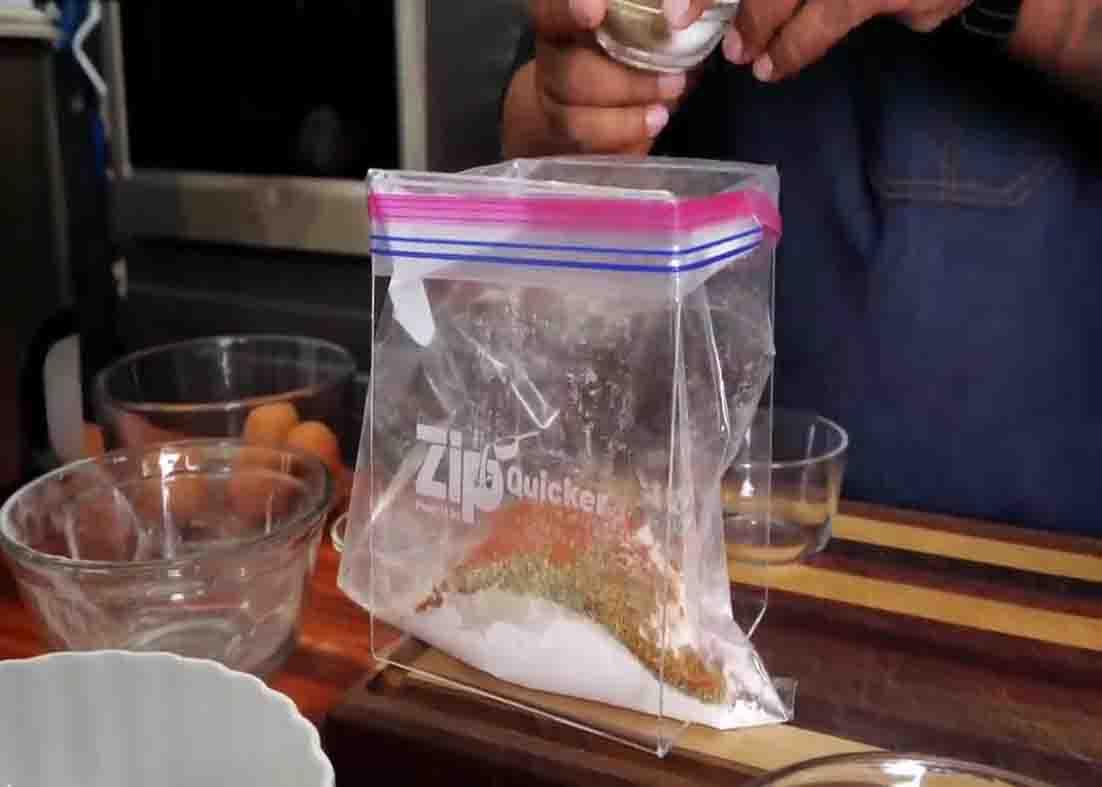 Mixing all the popcorn shrimp ingredients in the ziplock