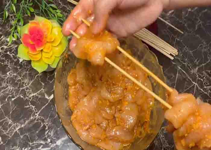 Adding the chicken to the skewers