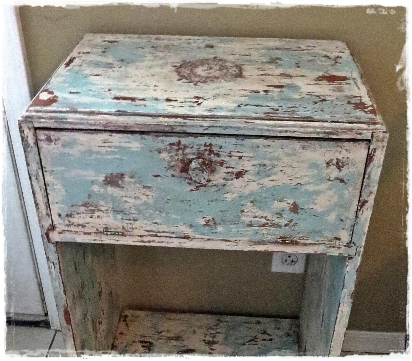 Distressed furniture DIY paint technique, a pale blue and white chippy nightstand with heavy crackle across the top