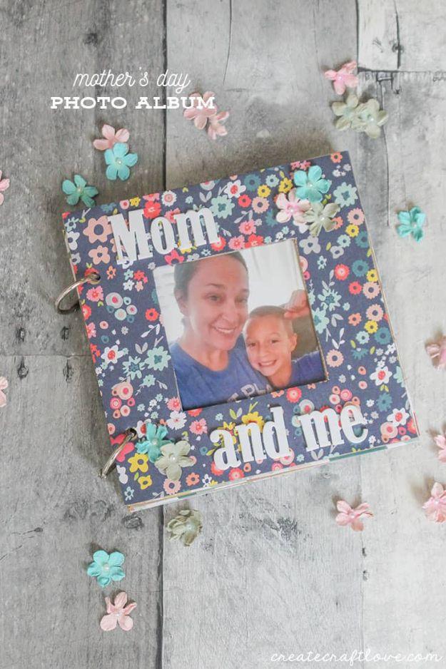 Typeset mother's day photo album graphic over a floral covered album with a cut out window photo on gray wood