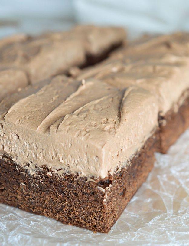 Irish cream chocolate brownies on plastic wrap with a thick swirled mocha colored whiskey frosting on top
