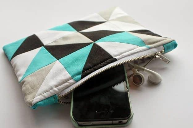 A zipper pouch with a pieced geometric front panel in blue and blush cotton triangles, cut from one fat quarter