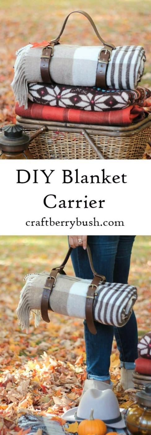 Leather blanket carrier for picnics, a rolled plaid blanket strapped in leather belts and carried beside a basket
